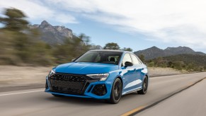 A blue Audi RS3 speeding down a highway, the Audi RS3 is a performance car with torque vectoring