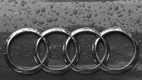 An Audi logo on a grey car.