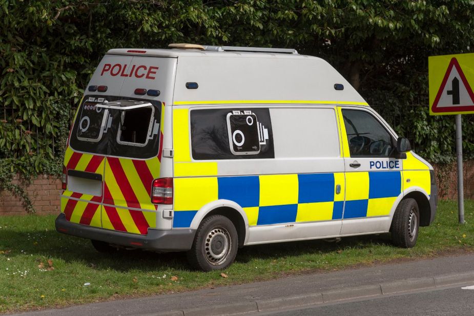 A police van parked by the roadside, its window up to photograph speeding motorists.