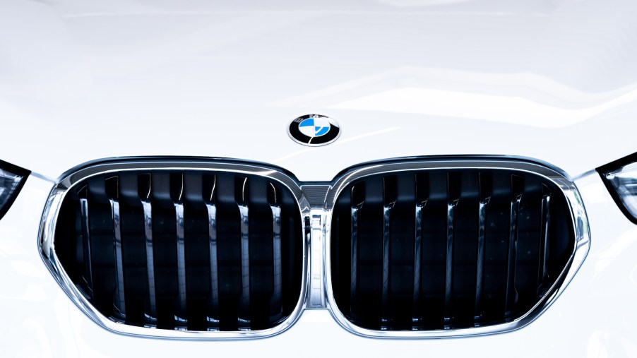 A white car boasting the BMW logo from the BMW group.