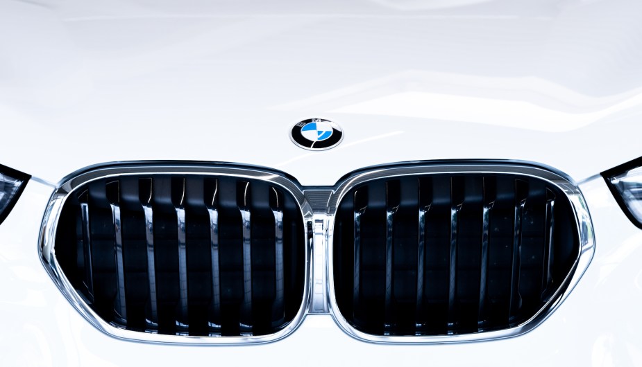 A white car boasting the BMW logo from the BMW group. 