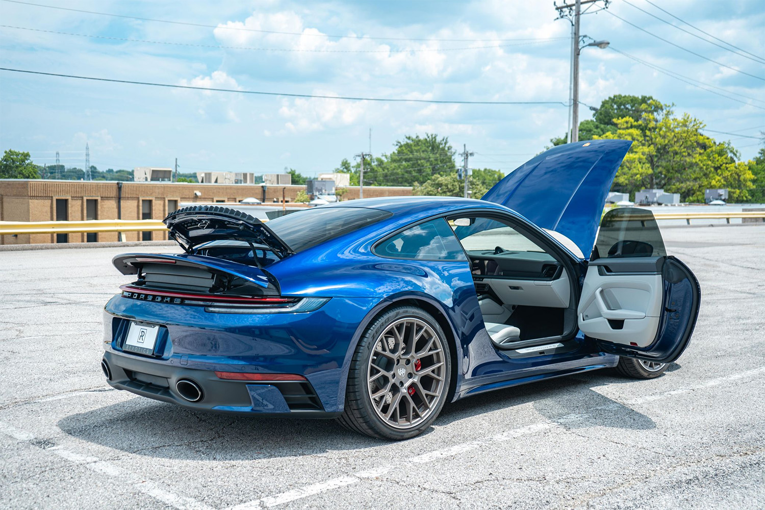 Blue 2022 Porsche 911 Carrera 4S Exploded View doors, hood, and decklid open