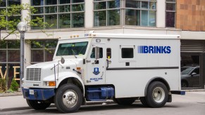 White Brinks armored security truck parked in front of a building