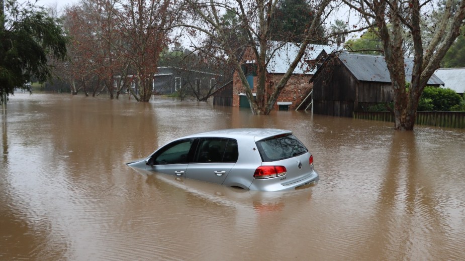 a car submerged in water after a flood, be wary of buying a used car after a major storm