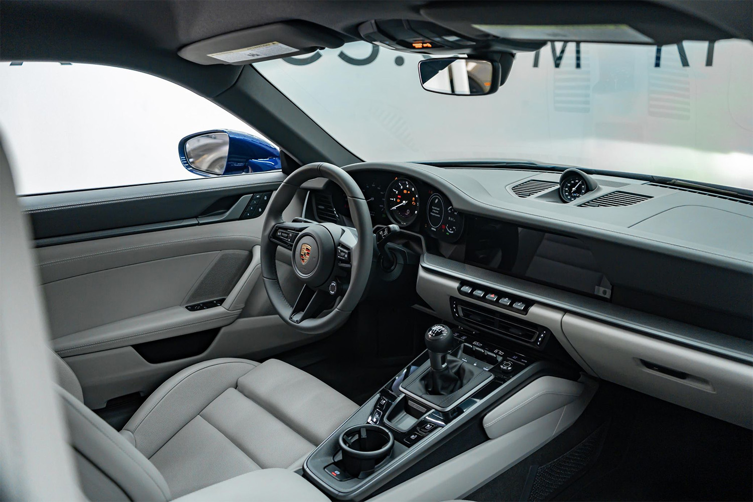 Chalf interior of blue metallic 2022 Porsche 911 Carrera 4S with seven-speed manual transmission