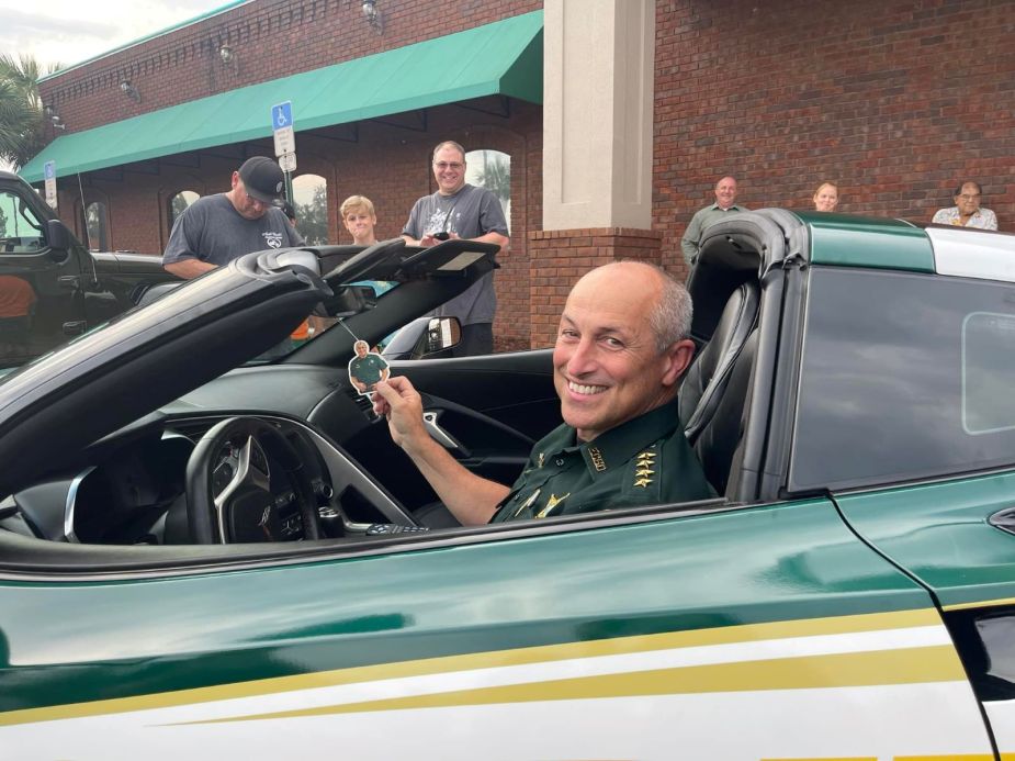 Chip Simmons of the Escambia County Sheriff's Office sitting in an seized 2017 Chevy Corvette Z06 wrapped in police decals