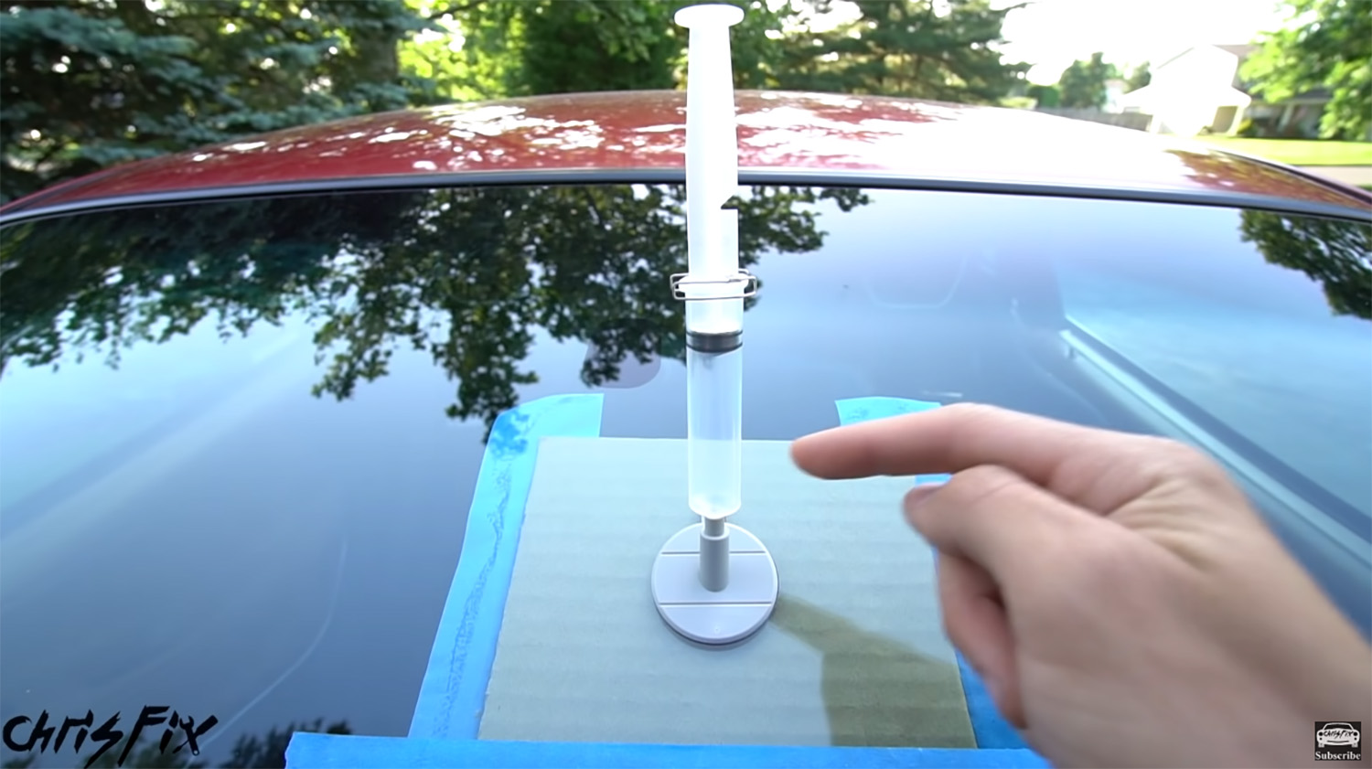 Vacuum chamber syringe plunger in use for DIY windshield rock chip repair