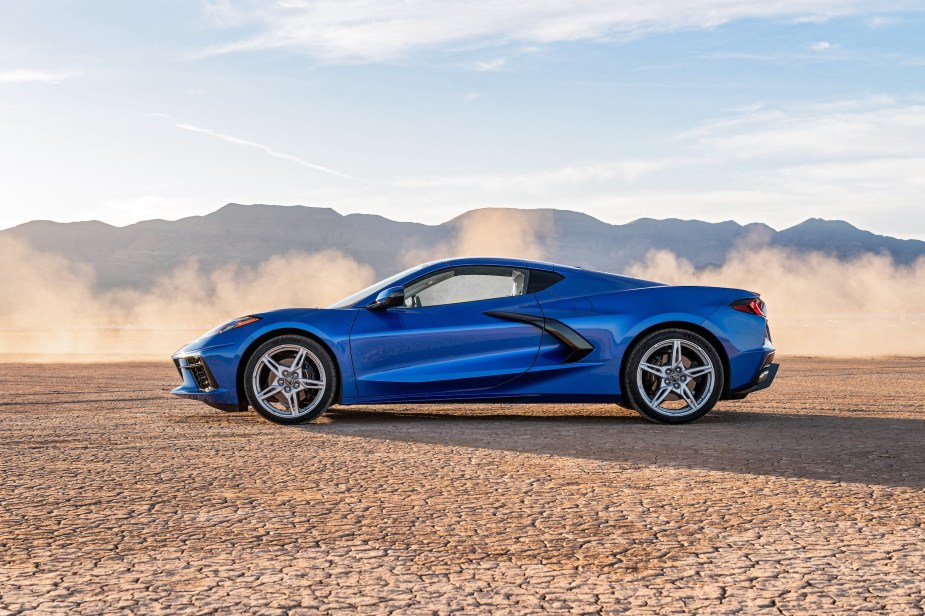 A blue Corvette Stingray parked in sand, the Corvette is among the most affordable supercars