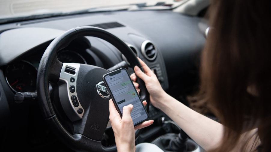 A distracted driver on their phone, one of the biggest mistakes people make while driving.