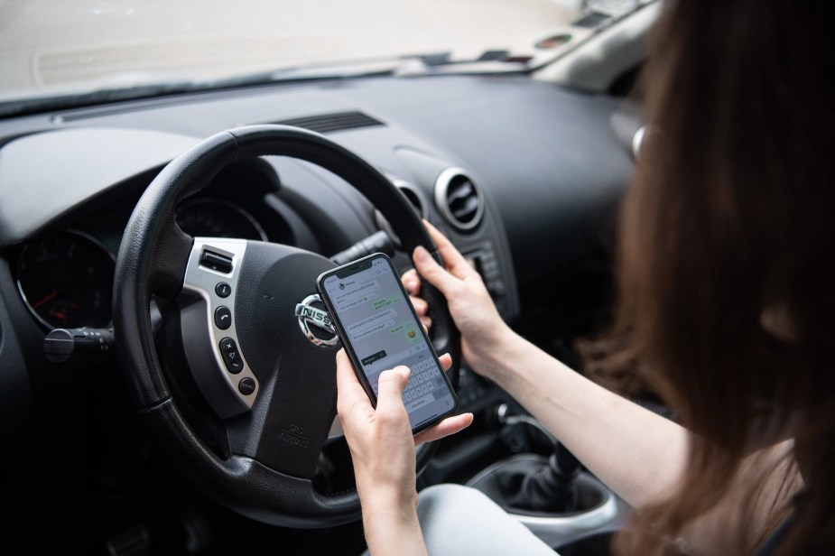 A distracted driver on their phone, one of the biggest mistakes people make while driving.