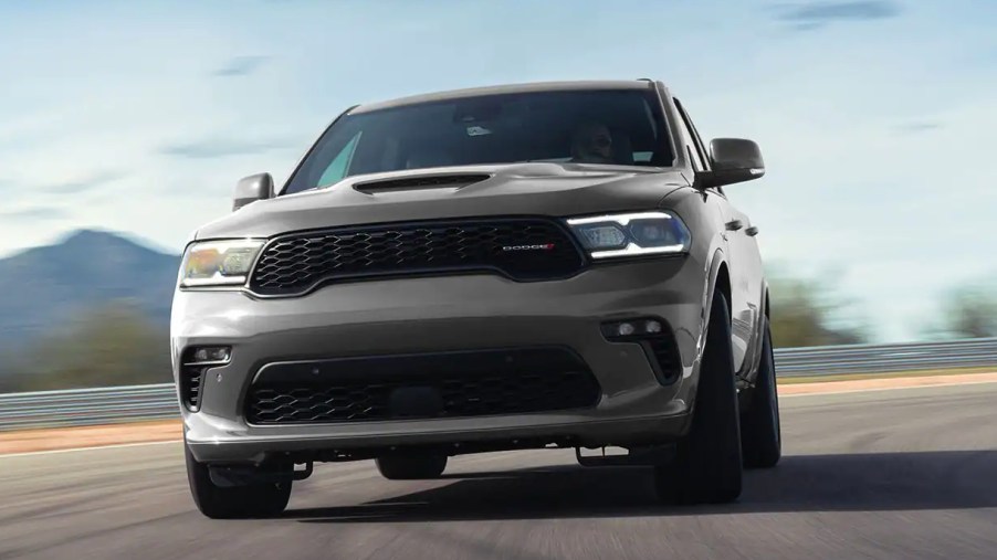 A gray 2022 Dodge Durango SUV is driving on the road.