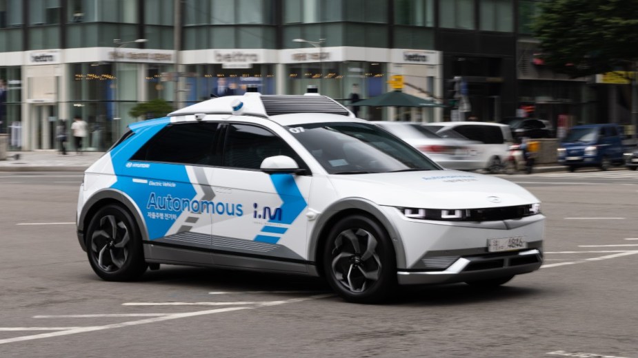 a driverless taxi testing on a busy city street