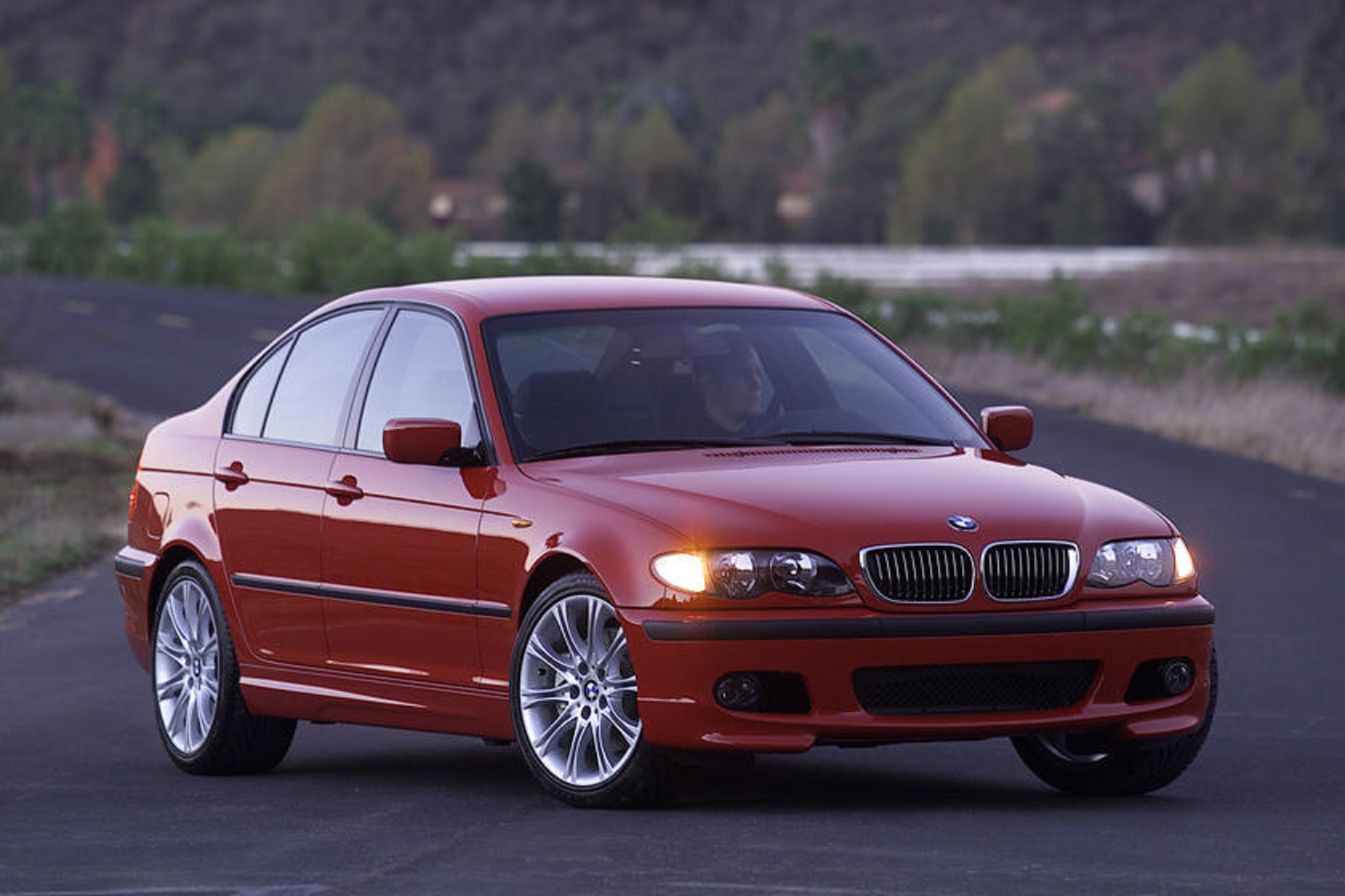A red E46 BMW 330i ZHP on a desert road