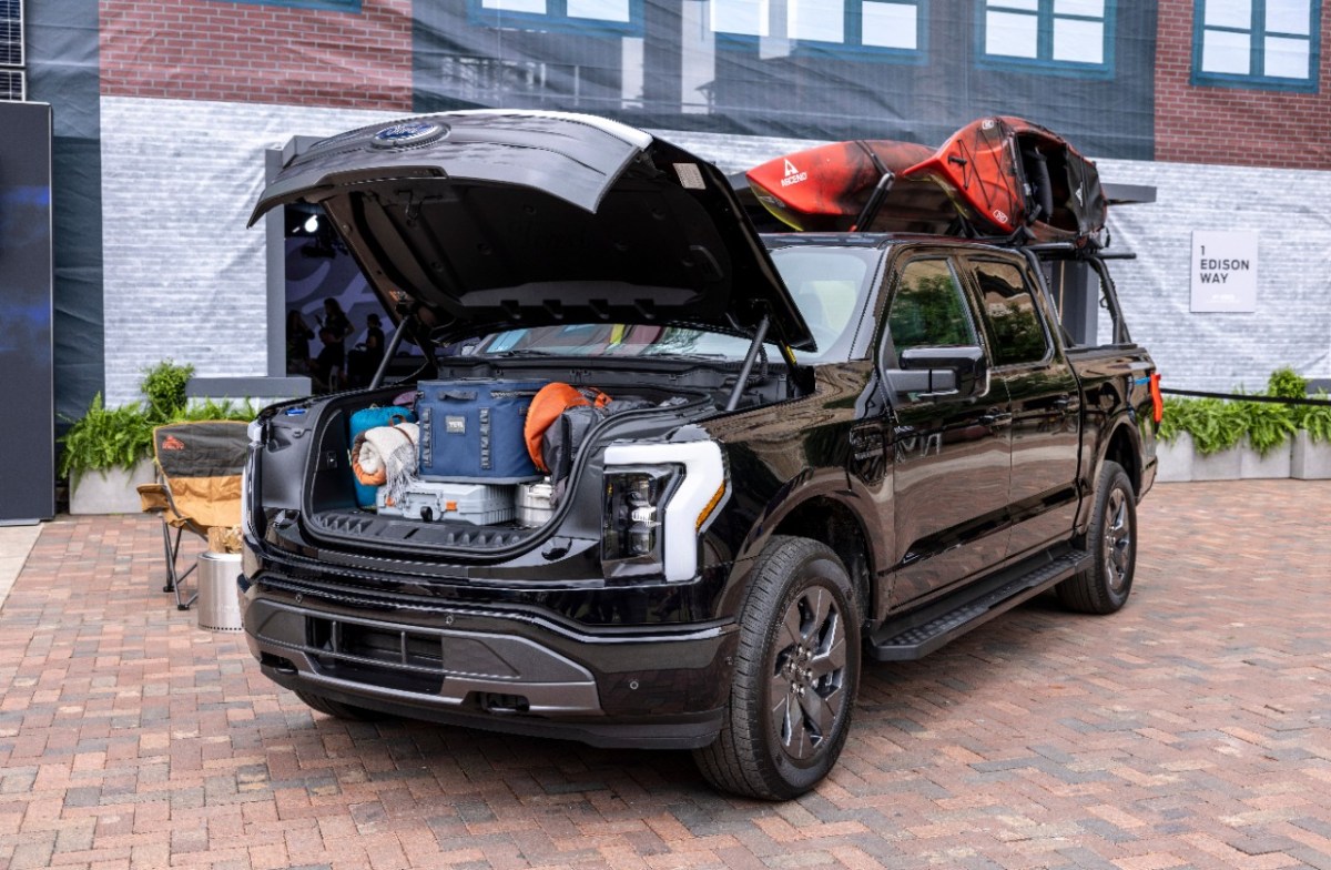 The Ford F-150 Lightning with its frunk full a nd a rack with kayaks. 