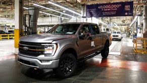 A silver Ford truck inside of the Ford factory.