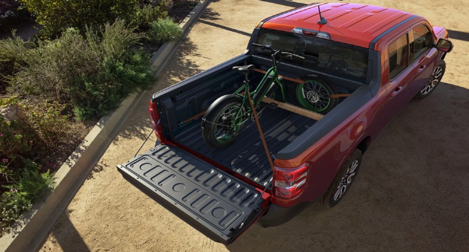 A green bike is packed into the 2022 Ford Maverick's flexbed.