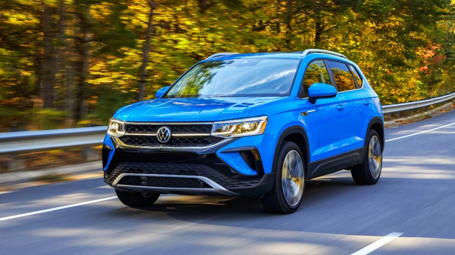Front angle view of blue 2023 Volkswagen Taos, highlighing its release date and price