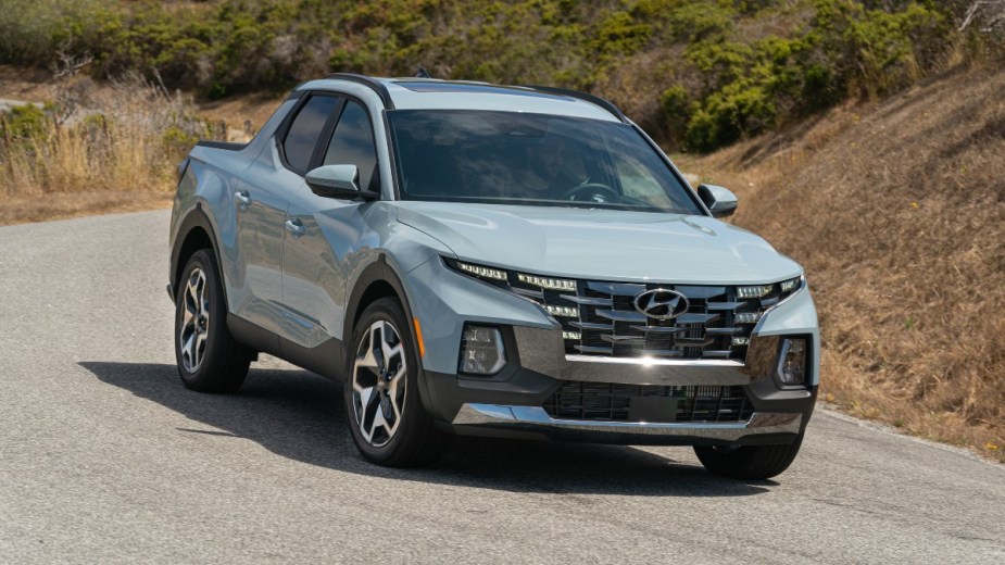 Front angle view of light blue 2023 Hyundai Santa Cruz pickup truck, highlighting its release date and price