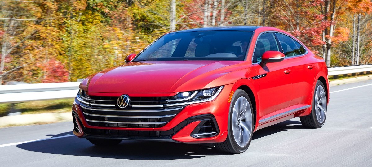 Front angle view of red 2023 Volkswagen Arteon midsize sedan, highlighting its release date and price