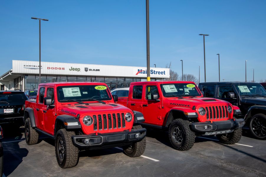 Car dealership lot displaying new 2021 vehicles on the lot.