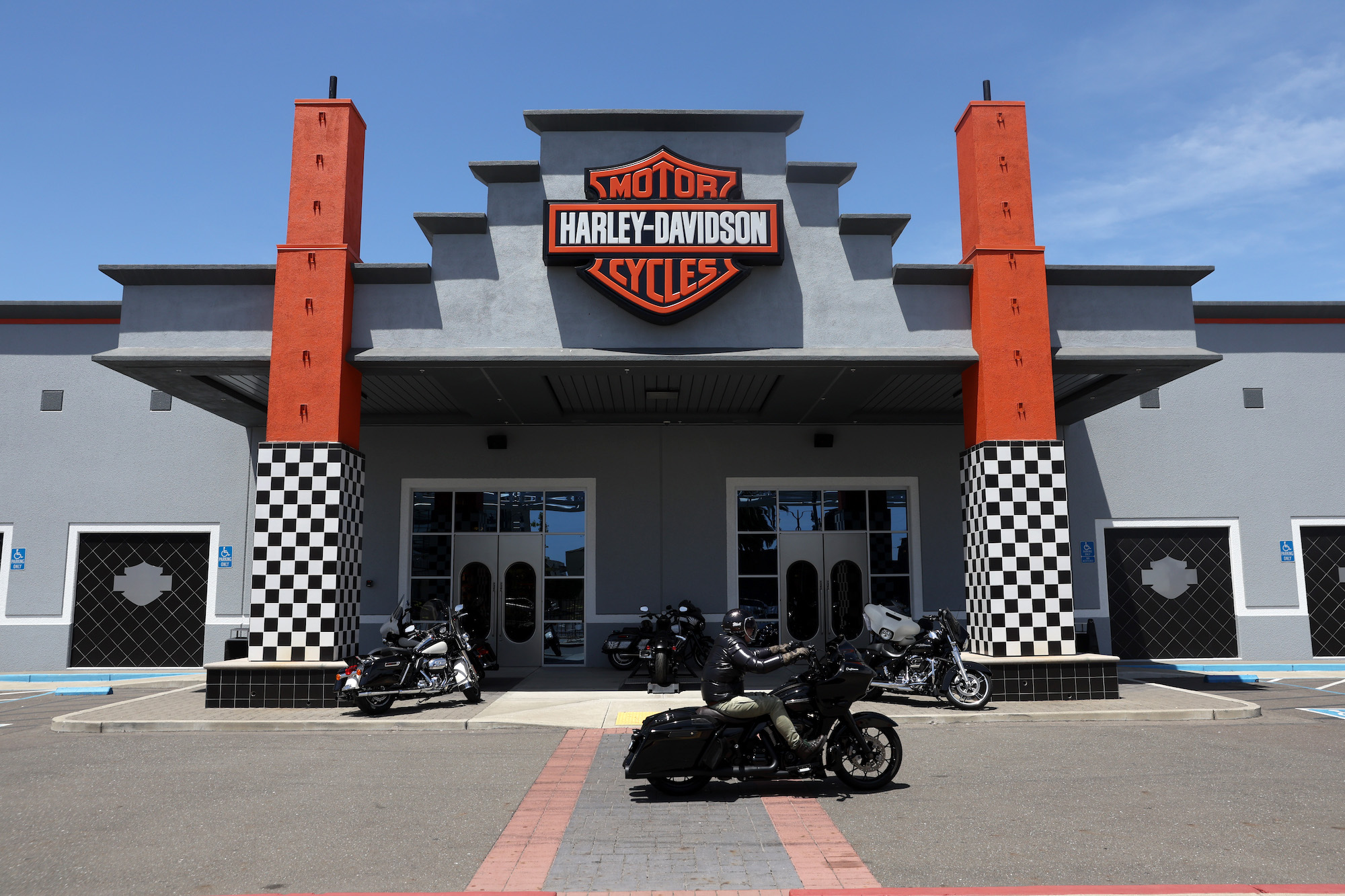 A Harley-Davidson dealership with bikes parked in front.