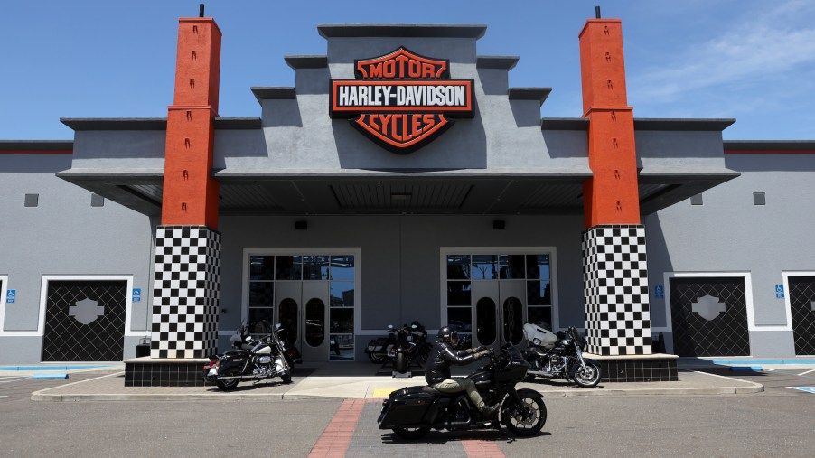 A Harley-Davidson dealership with bikes parked in front.