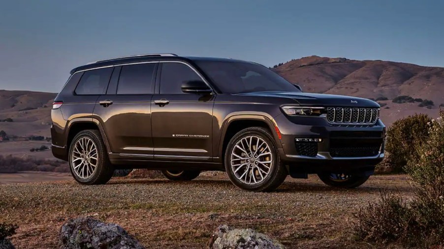 A green 2023 Jeep Grand Cherokee midsize SUV is parked.