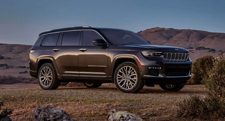 A green 2023 Jeep Grand Cherokee midsize SUV is parked. 