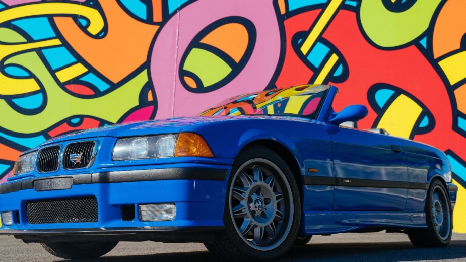 a late 90s bmw m3 e36 against a multi color background, a image and aesthetic reminiscent of the 90s