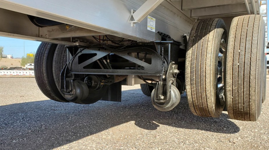 Tractor trailer lift axle in action.