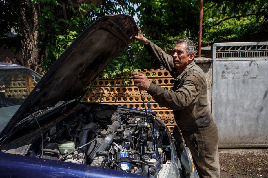 A mechanic performing car maintenance. 