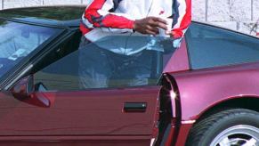 Michael Jordan with one of his car collection staples, a ruby red C4 Corvette ZR1 40th Anniversary Edition