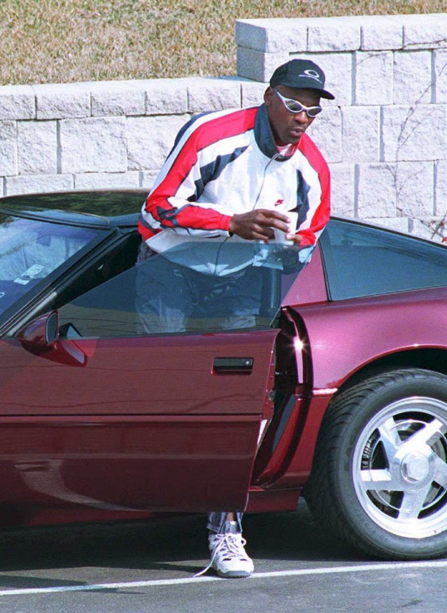 Michael Jordan with one of his car collection staples, a ruby red C4 Corvette ZR1 40th Anniversary Edition