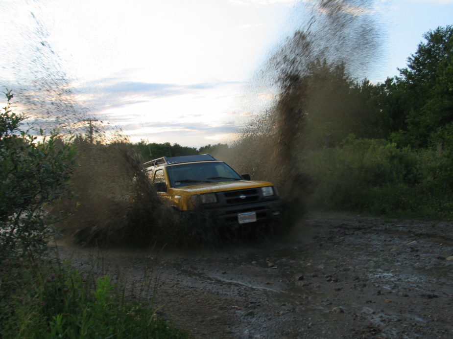 A yellow Nissan Xterra demonstrates its off-road ability.