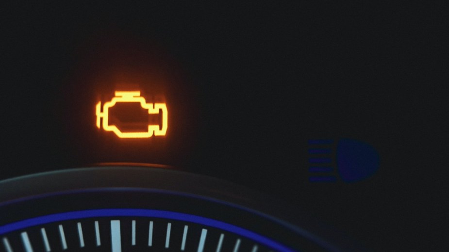 an engine oil light lit up on a dashboard, checking your oil is a simple service to keep your new car in better shape