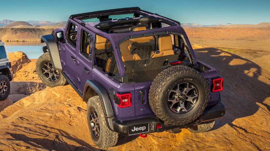 Rear angle view of 2023 Jeep Wrangler with purple Reign color, highlighting its release date and price