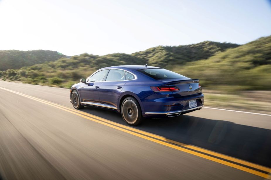 Rear angle view of blue 2023 VW Arteon midsize sedan, highlighting its release date and price