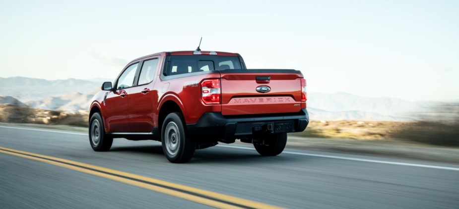 Rear angle view of orange 2023 Ford Maverick pickup truck, highlighting its release date and price