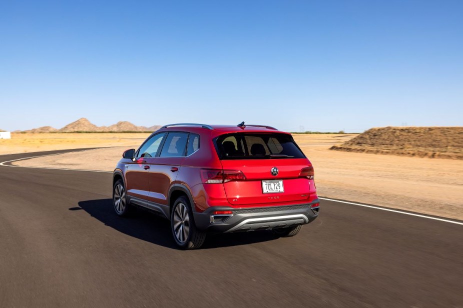 Rear angle view of red 2023 Volkswagen Taos, highlighing its release date and price