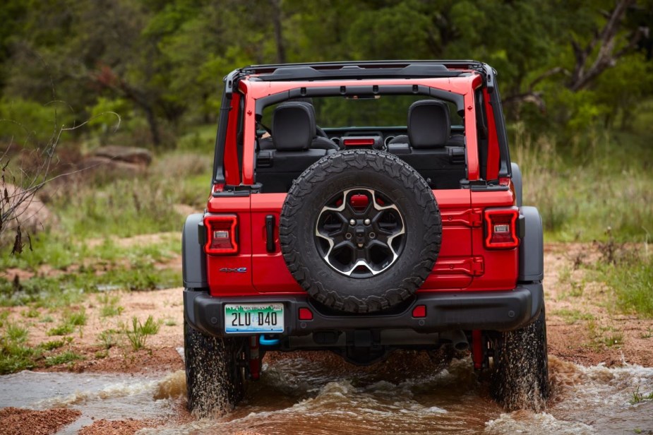 Rear view of red 2023 Jeep Wrangler 4xe, highlighting its release date and price