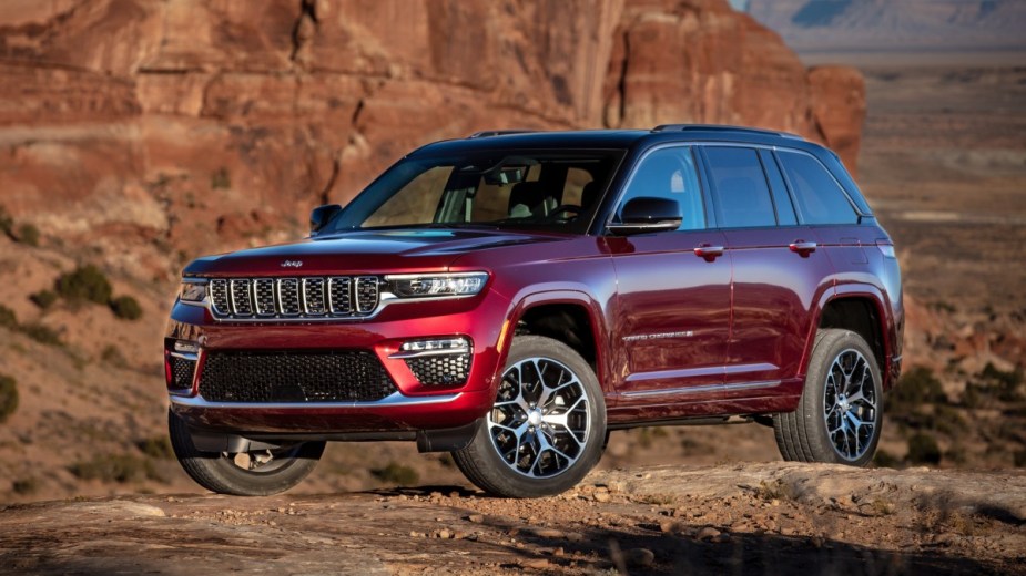 Red 2023 Jeep Grand Cherokee parked on a hill, highlighting its release date and specs