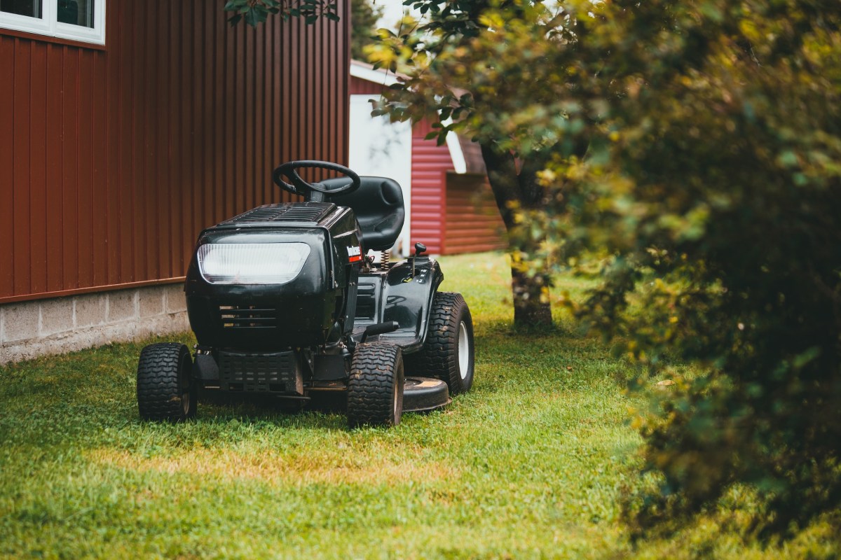 Pictured is a riding lawn mower hidden among trees
