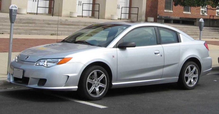 The Saturn Ion Redline in silver parked on the side of the road.