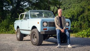 the Scout Motor CEO sitting on a vintage Scout SUV