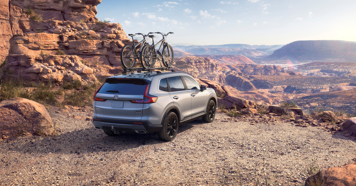 Silver 2023 Honda CR-V parked on an overlook point, highlighting its release date and price