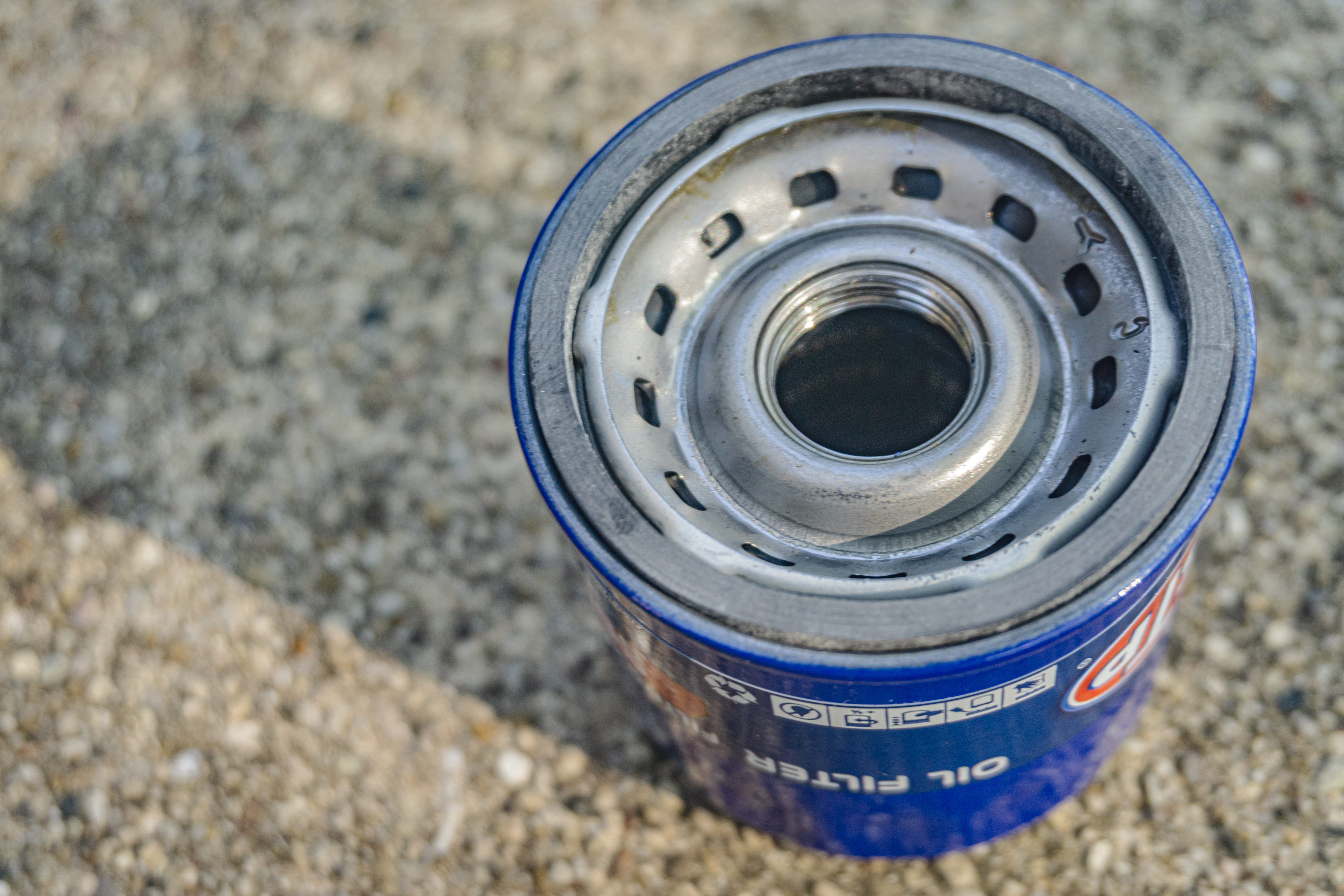 A close-up view of the top and interior of a blue spin-on oil filter