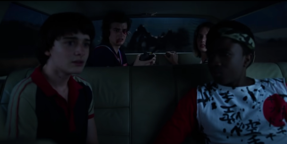The cast of Stranger Things inside the Wheeler family's Mercury station wagon.