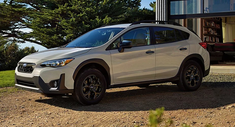 A white Subaru Crosstrek subcompact SUV is parked outdoors.