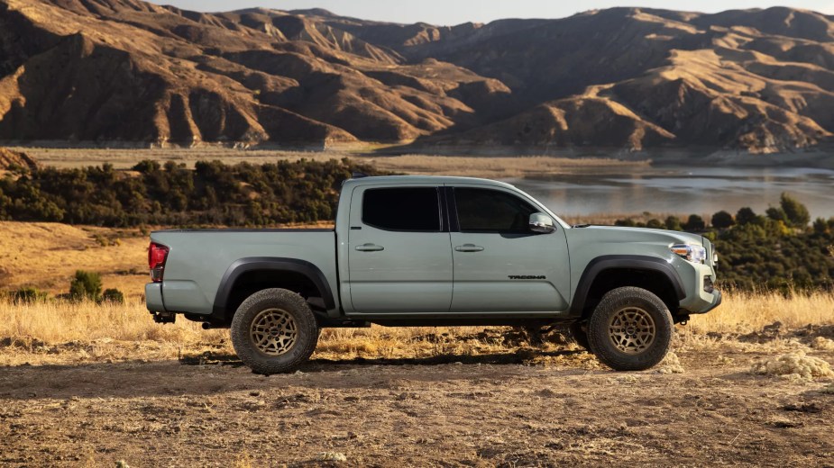 A 2022 Toyota Tacoma midsize truck driving in the dirt. JD Power likes the cheapest ones best.