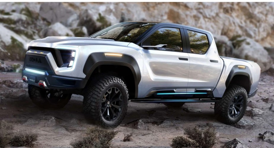 A white 2024 Toyota Tacoma Electric pickup truck  concept is driving off-road. 
